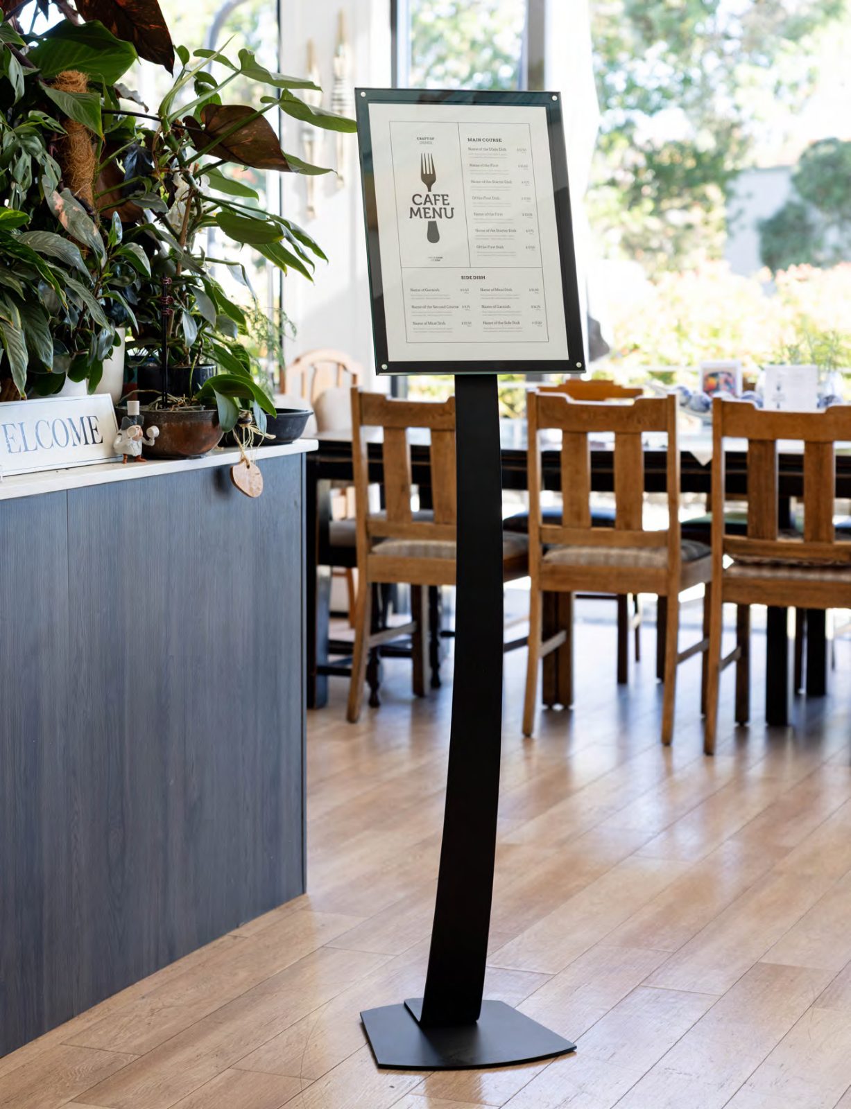 A menu sign on a freestanding stand beside a café counter